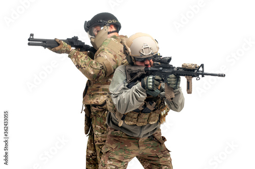American special forces. two soldiers in military equipment with guns attack on a white background, USA Army aims and shoots
