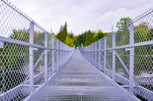 Suspended metal bridge over the river