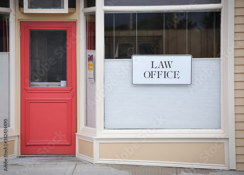 Law office sign hanging in glass window