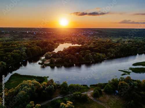 Fototapeta Naklejka Na Ścianę i Meble -  Sunset above the river in natural rural landscape