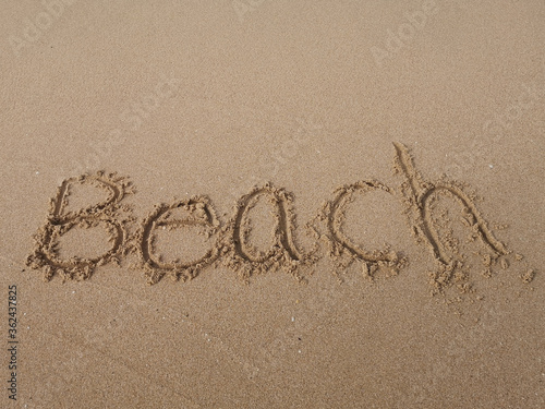 "Beach" written in the sand