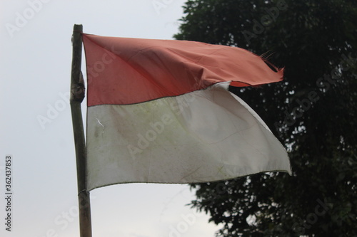 The Indonesian flag is flying above the mountain. Flag in the mountains.