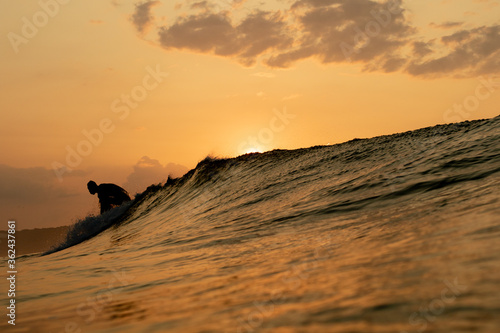 Sunrise in Japan while swimming in the Ocean amongst the waves on the Pacific coast line close to Tokyo city. The sky is stunning & shows why its called the Land of the rising sun.