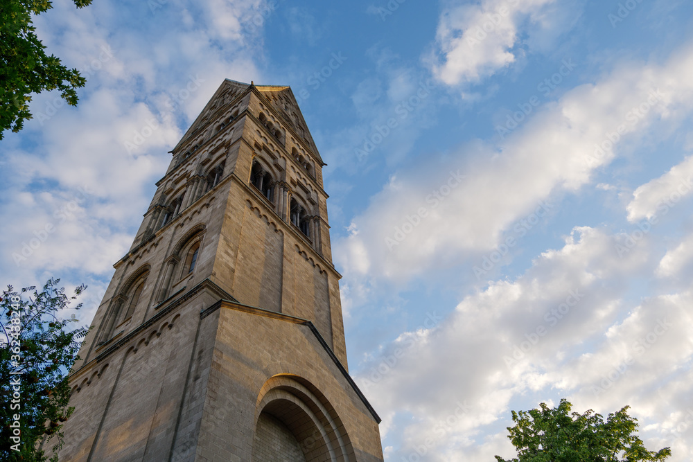 Obraz premium Low angle view at the tower of Rochuskirche, Saint Rochus Catholic Church, in Düsseldorf, Germany against blue sky. 