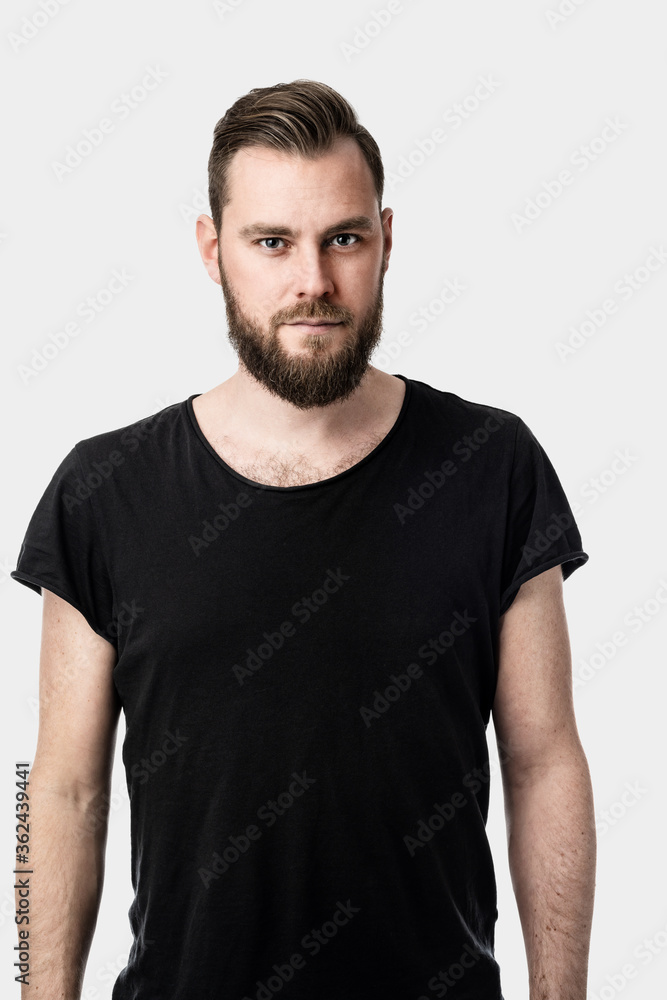 An image of a
serious-looking handsome caucasian man looking
towards the camera wearing a black shirt alone on white background. An image of a
serious-looking handsome caucasian man looking
towards the camera wearing a black shirt alone on white background.