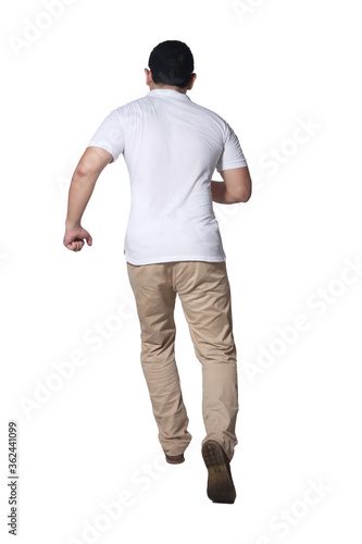 Full length portrait of Asian man wearing white shirt and khaki jeans standing running, rear view