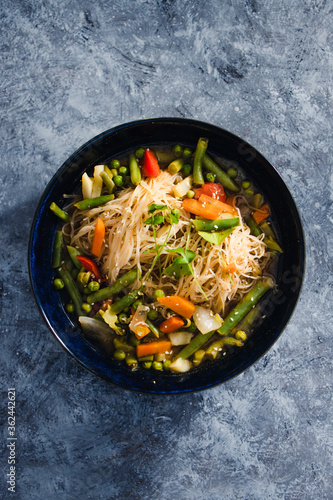 plant-based food, vegan singaporean laksa soup with vermicelli noodles and stir fry veggies