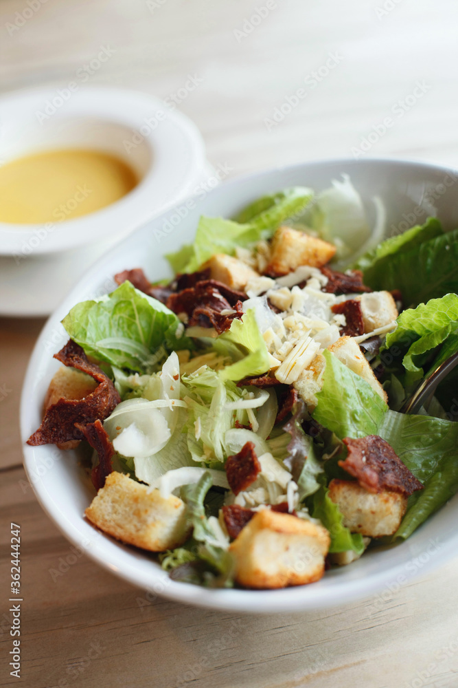 A bowl of salad with croutons A bowl of salad with croutons