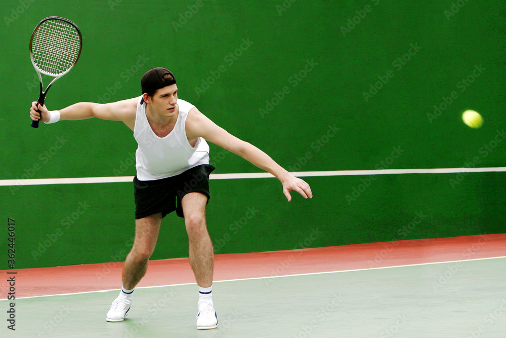 A man playing tennis in the tennis court