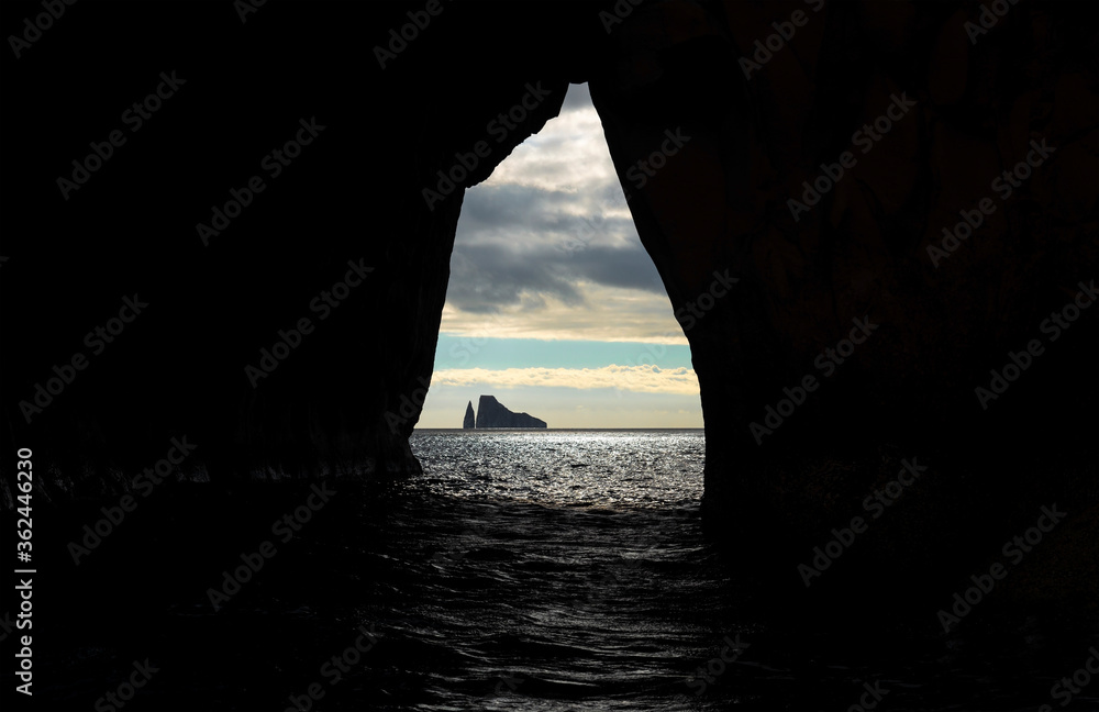 Kicker Rock seen from a cave at sunset near San Cristobal island in the Pacific Ocean, Galapagos national park, Ecuador.