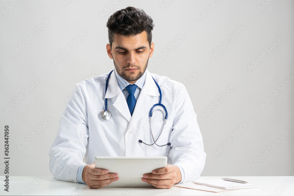 Young arab internist using tablet computer Young arab internist using tablet computer