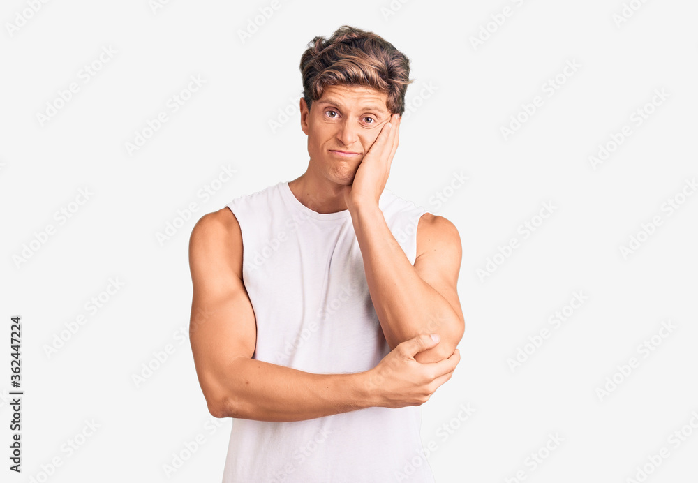 Young handsome man wearing sleveeless t shirt thinking looking tired and bored with depression problems with crossed arms. Young handsome man wearing sleveeless t shirt thinking looking tired and bored with depression problems with crossed arms.