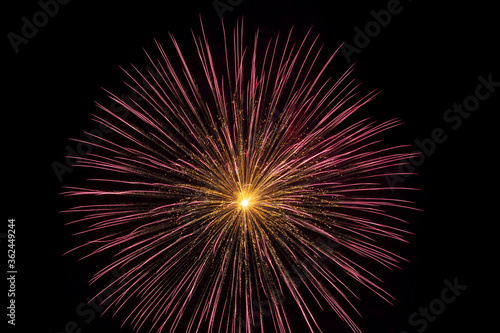 A very large and colorful firework explodes in the night sky in a celebration of freedom on the Fourth of July.