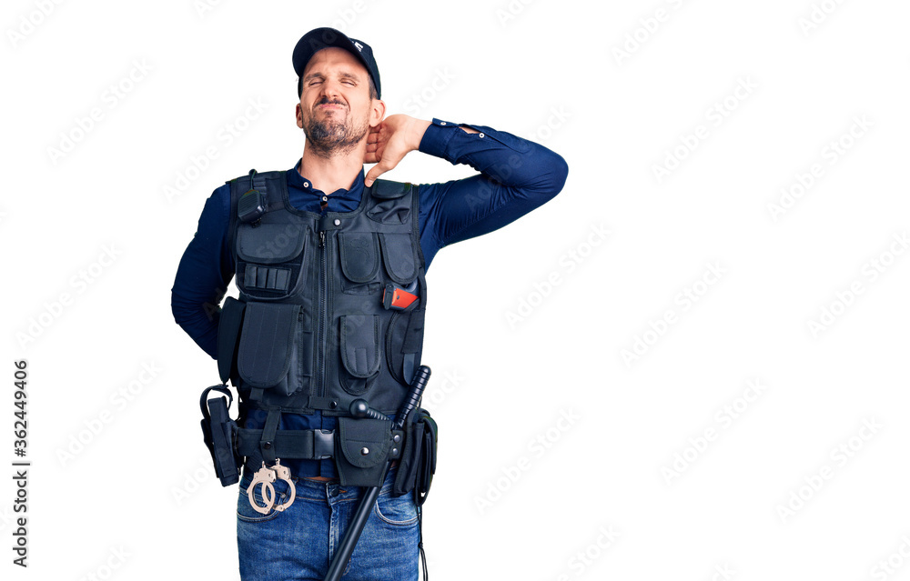 Young handsome man wearing police uniform suffering of neck ache injury, touching neck with hand, muscular pain Young handsome man wearing police uniform suffering of neck ache injury, touching neck with hand, muscular pain