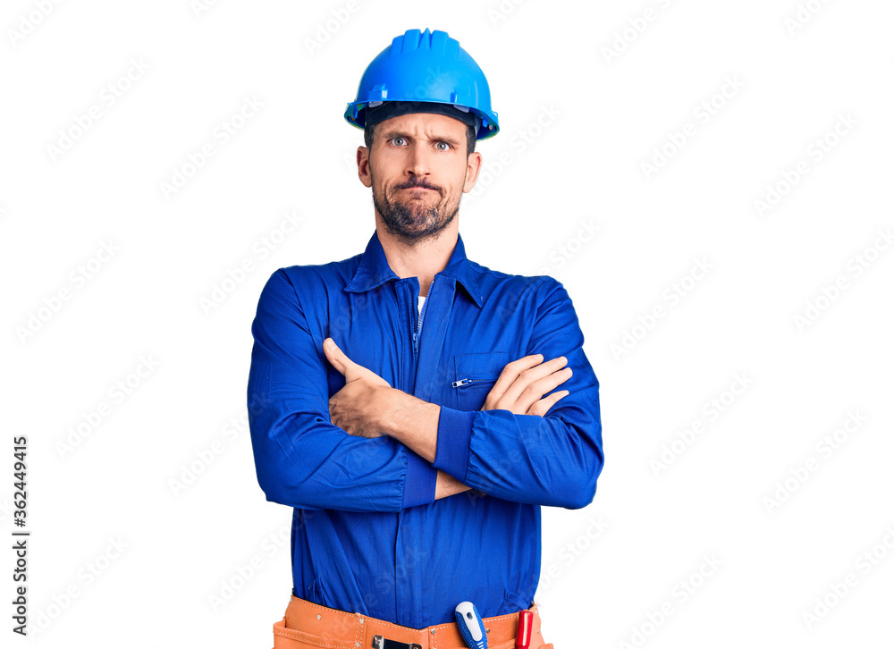 Young handsome man wearing worker uniform and hardhat shocked covering mouth with hands for mistake. secret concept. Young handsome man wearing worker uniform and hardhat shocked covering mouth with hands for mistake. secret concept.