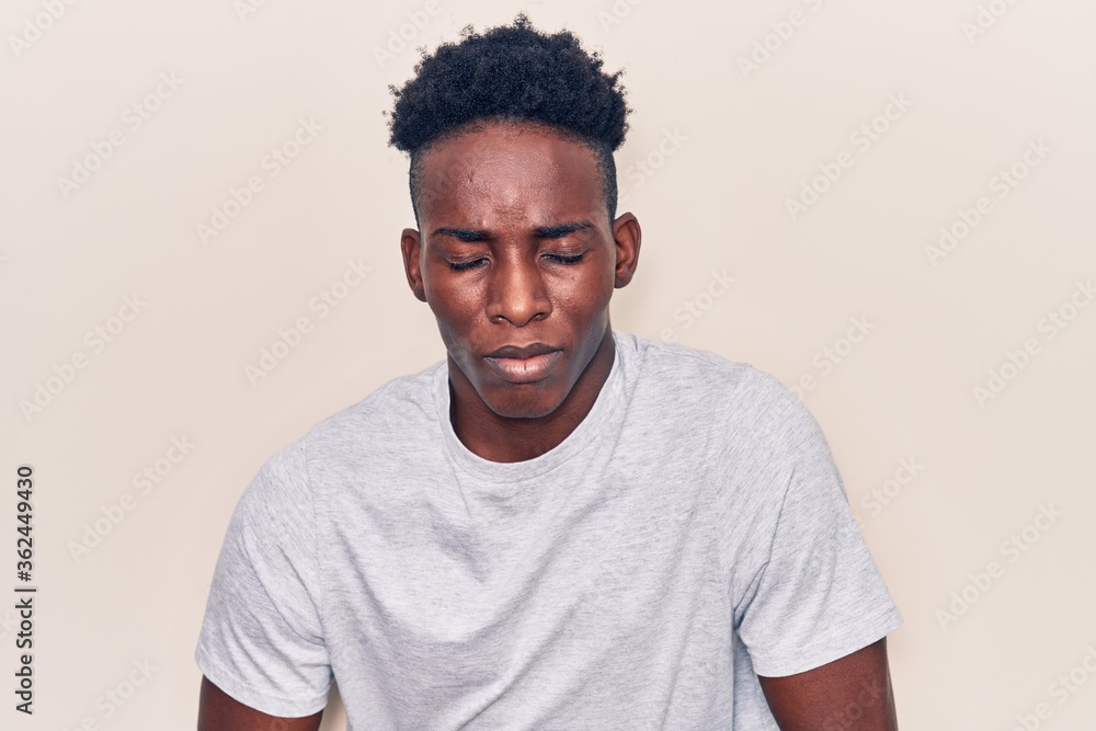 Young african american man wearing casual clothes with hand on stomach because indigestion, painful illness feeling unwell. ache concept. Young african american man wearing casual clothes with hand on stomach because indigestion, painful illness feeling unwell. ache concept.