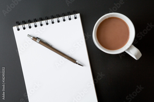 Notebooks , pen , coffee cup on black background