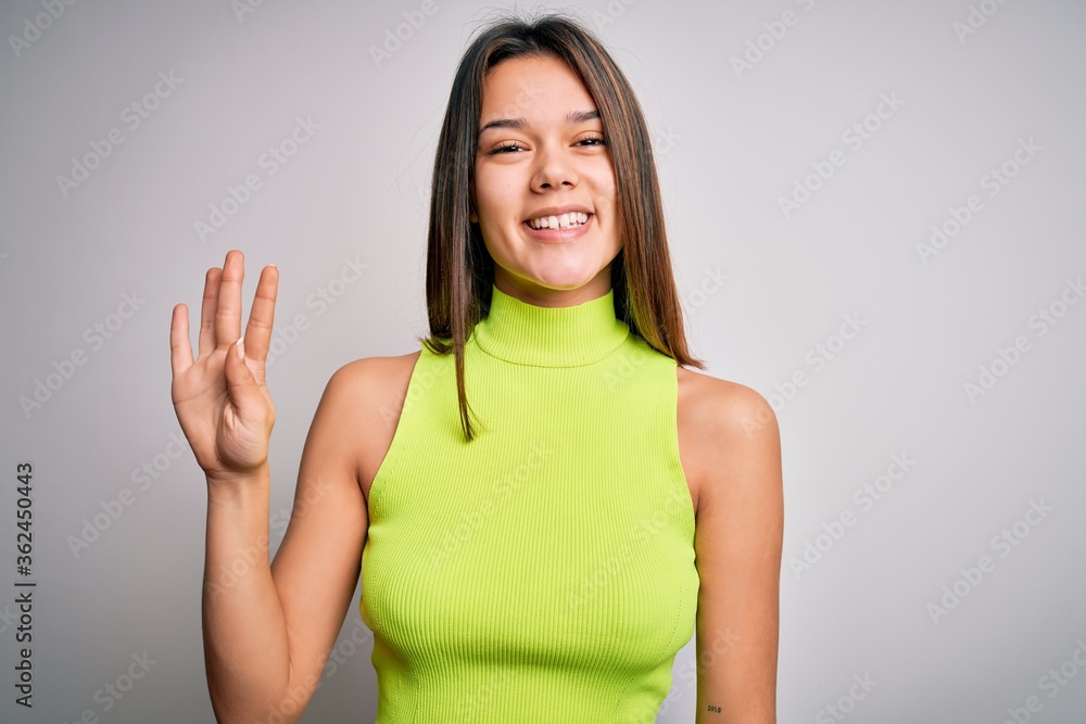 Young beautiful brunette girl wearing casual summer t-shirt over isolated white background showing and pointing up with fingers number four while smiling confident and happy. Young beautiful brunette girl wearing casual summer t-shirt over isolated white background showing and pointing up with fingers number four while smiling confident and happy.