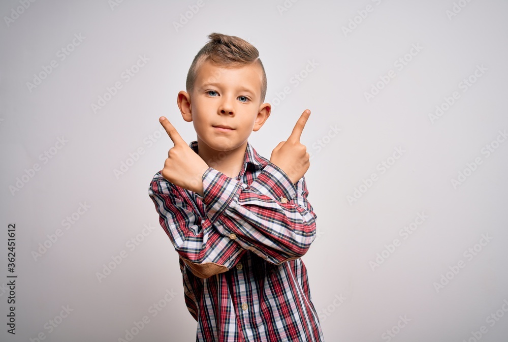 Young little caucasian kid with blue eyes wearing elegant shirt standing over isolated background Pointing to both sides with fingers, different direction disagree Young little caucasian kid with blue eyes wearing elegant shirt standing over isolated background Pointing to both sides with fingers, different direction disagree