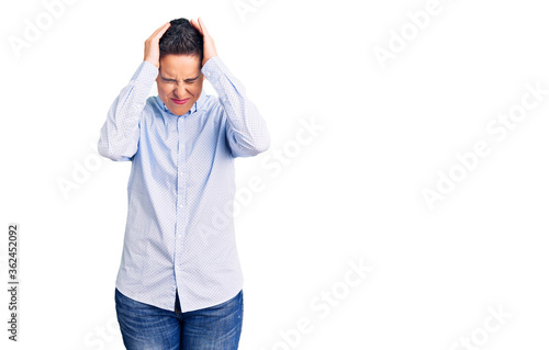 Young woman with short hair wearing business clothes suffering from headache desperate and stressed because pain and migraine. hands on head. © Krakenimages.com