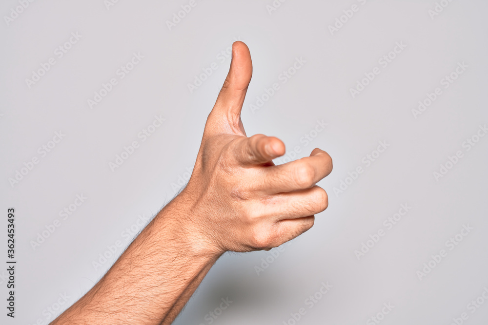Hand of caucasian young man showing fingers over isolated white background pointing forefinger to the camera, choosing and indicating towards direction Hand of caucasian young man showing fingers over isolated white background pointing forefinger to the camera, choosing and indicating towards direction