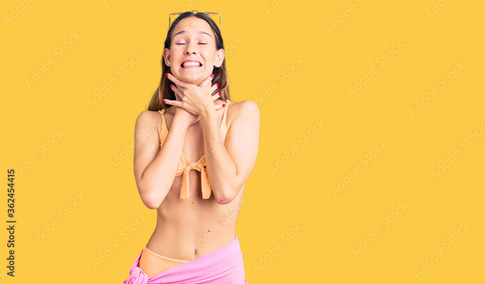 Beautiful brunette young woman wearing bikini and sunglasses shouting and suffocate because painful strangle. health problem. asphyxiate and suicide concept. Beautiful brunette young woman wearing bikini and sunglasses shouting and suffocate because painful strangle. health problem. asphyxiate and suicide concept.
