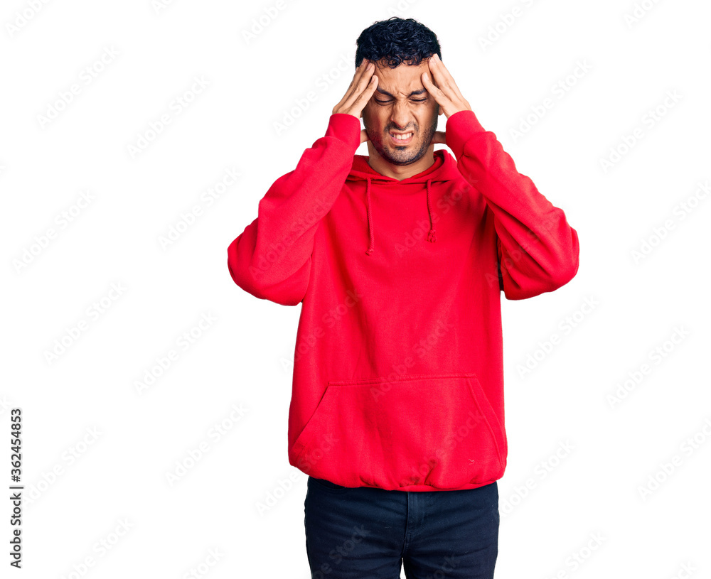 Young hispanic man wearing casual clothes suffering from headache desperate and stressed because pain and migraine. hands on head. Young hispanic man wearing casual clothes suffering from headache desperate and stressed because pain and migraine. hands on head.
