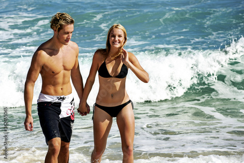 A couple taking a stroll on the beach