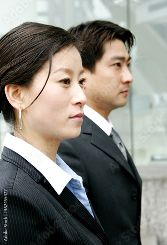 Side shot of a woman and a man in office attire