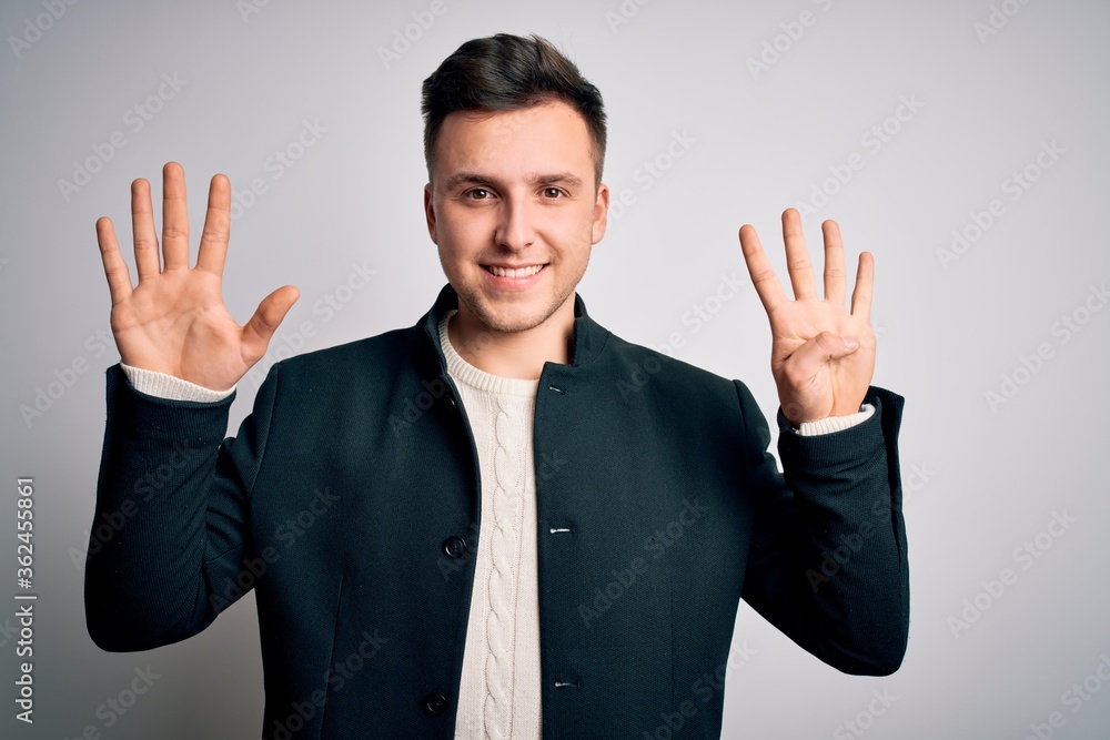 Young handsome business mas wearing elegant winter coat standing over isolated background showing and pointing up with fingers number nine while smiling confident and happy. Young handsome business mas wearing elegant winter coat standing over isolated background showing and pointing up with fingers number nine while smiling confident and happy.