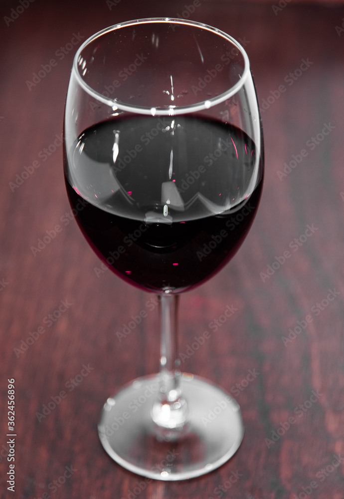 Glass of merlot wine with background
