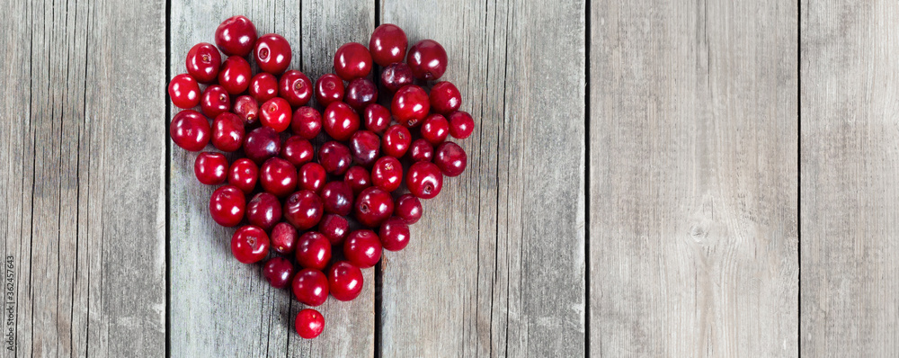Cherry heart shape on a wooden rustic background