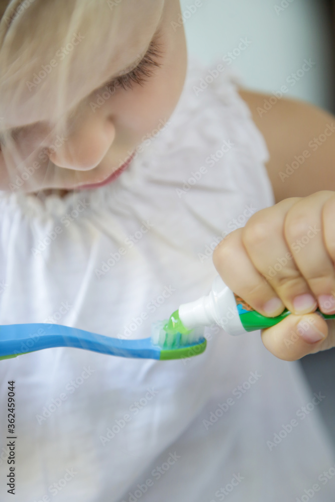 Adorable 3 years old girl brushing her teeth in bathroom. Adorable 3 years old girl brushing her teeth in bathroom.