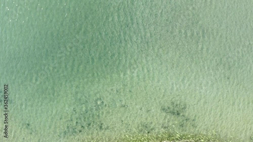 Interesting bird’s eye view approaching to crystal clear waters from Pillersee lake in Tyron Austria. Light flow. photo