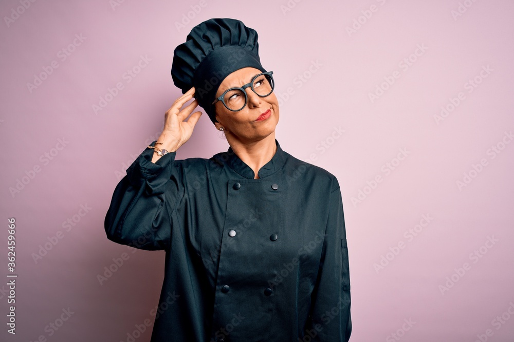 Middle age brunette chef woman wearing cooker uniform and hat over isolated pink background confuse and wondering about question. Uncertain with doubt, thinking with hand on head. Pensive concept. Middle age brunette chef woman wearing cooker uniform and hat over isolated pink background confuse and wondering about question. Uncertain with doubt, thinking with hand on head. Pensive concept.