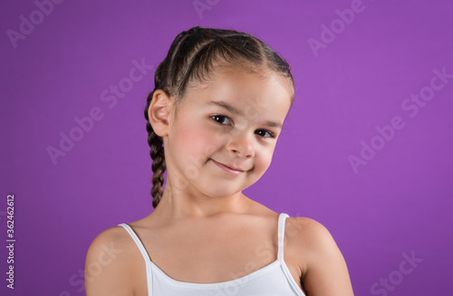 Canvas Print Portrait beautiful biracial little girl with sassy expression on purple backgrou
