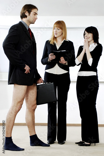 Fotografi Businesswomen laughing at their colleague for not wearing pants to work