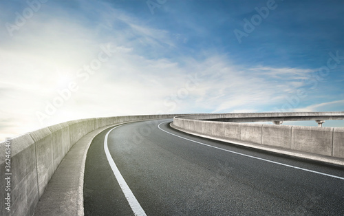 Obraz na plátně Curvy flyover asphalt road on sky background.