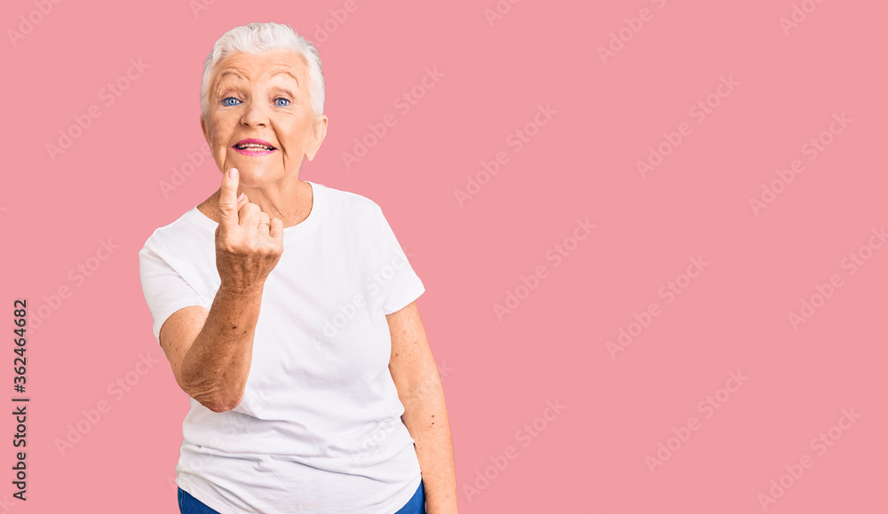 Senior beautiful woman with blue eyes and grey hair wearing casual white tshirt beckoning come here gesture with hand inviting welcoming happy and smiling Senior beautiful woman with blue eyes and grey hair wearing casual white tshirt beckoning come here gesture with hand inviting welcoming happy and smiling