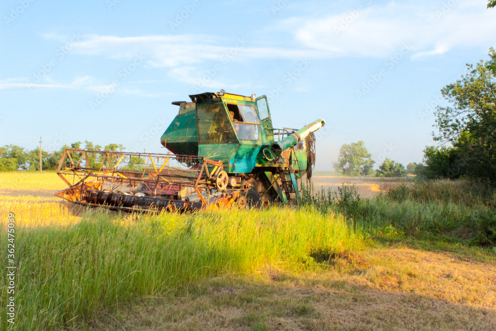 combine harvester working in a field combine harvester working in a field
