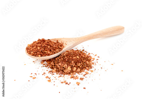 red ground paprika powdered or dry chili pepper with wooden spoon isolated on white background