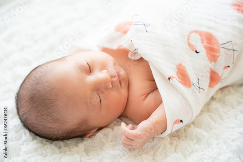 おくるみに包まって眠っている日本人の赤ちゃんの寝顔 新生児のニューボーンフォト Stock Photo Adobe Stock