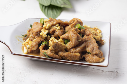 Stir Fried Pork with Green Curry Paste in a White Background