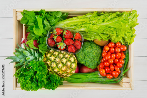 Variety vegetables and fruits in wooden box