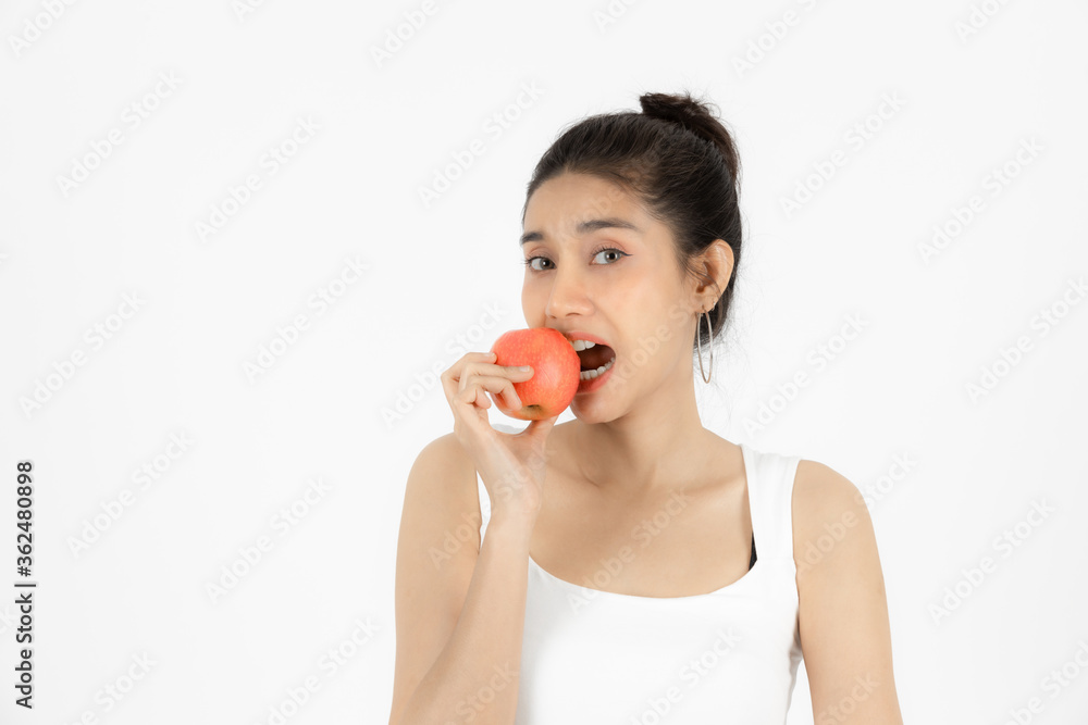 Healthy young Asian woman eating fresh apple over white isolated background. Vegetarian, Healthy lifestyle, Fitness and health care concept. Healthy young Asian woman eating fresh apple over white isolated background. Vegetarian, Healthy lifestyle, Fitness and health care concept.