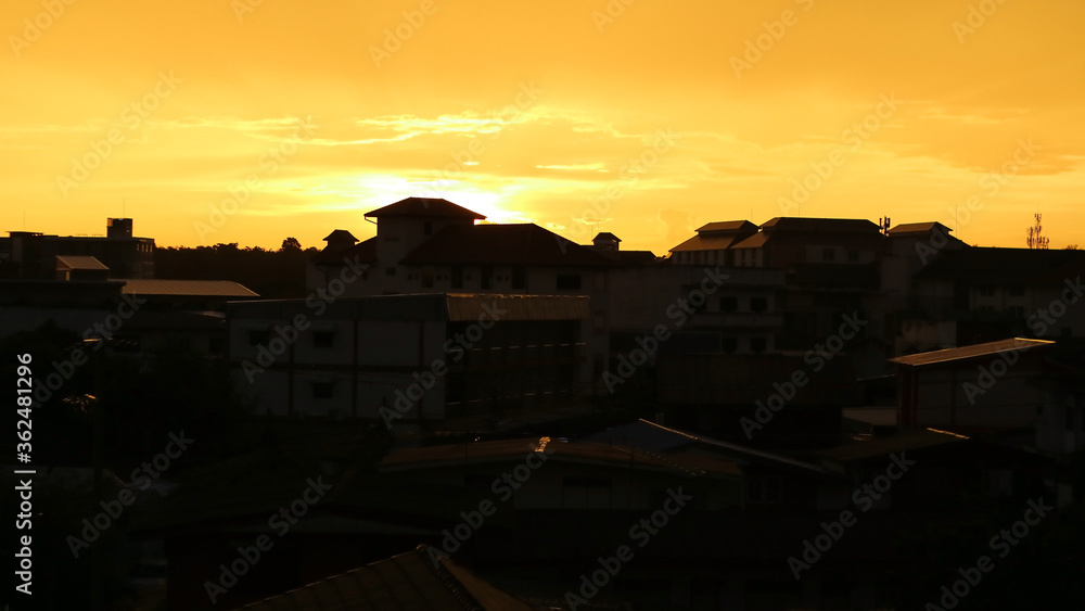 The beautiful of the silhouette of the isolated city or buildings with shadow at sunset, Orange sky