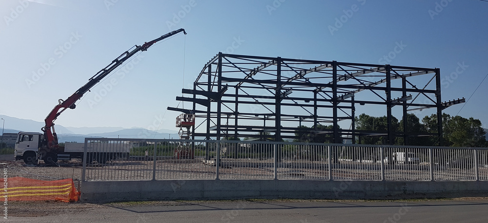 Naklejka premium construction of building home from iron parts crane workiing
