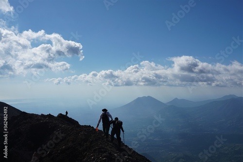 friends on top of mountain, helping each other © Humberto
