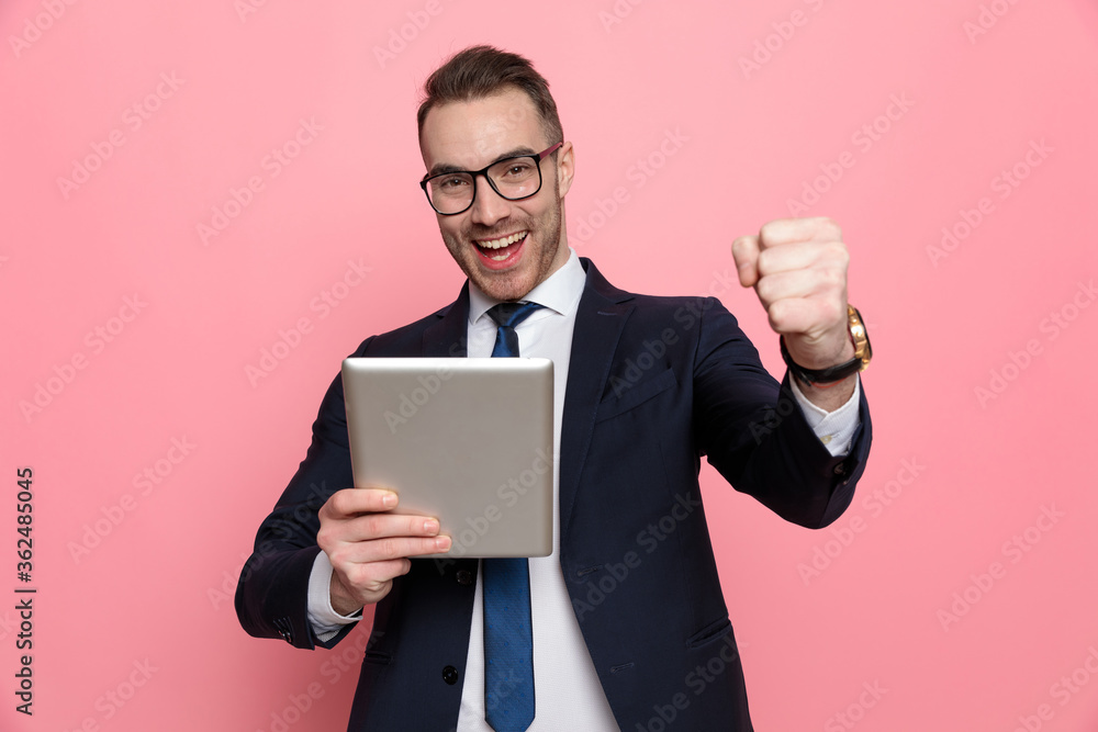 enthusiastic elegant guy reading emails and celebrating victory enthusiastic elegant guy reading emails and celebrating victory