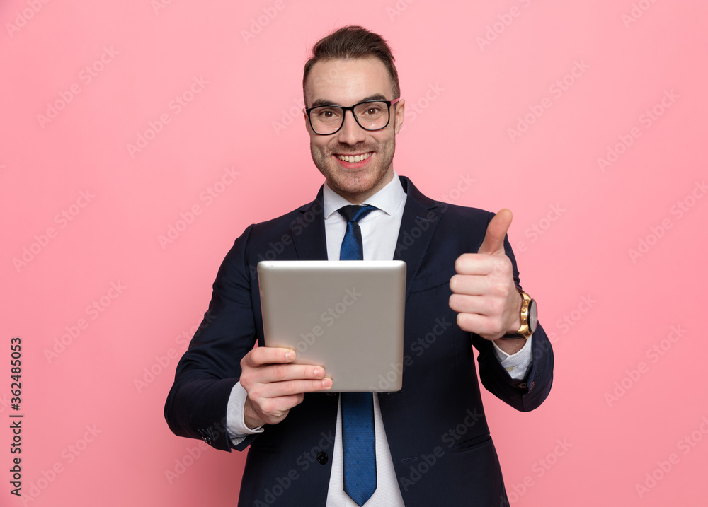 happy young businessman in suit making thumbs up sign happy young businessman in suit making thumbs up sign